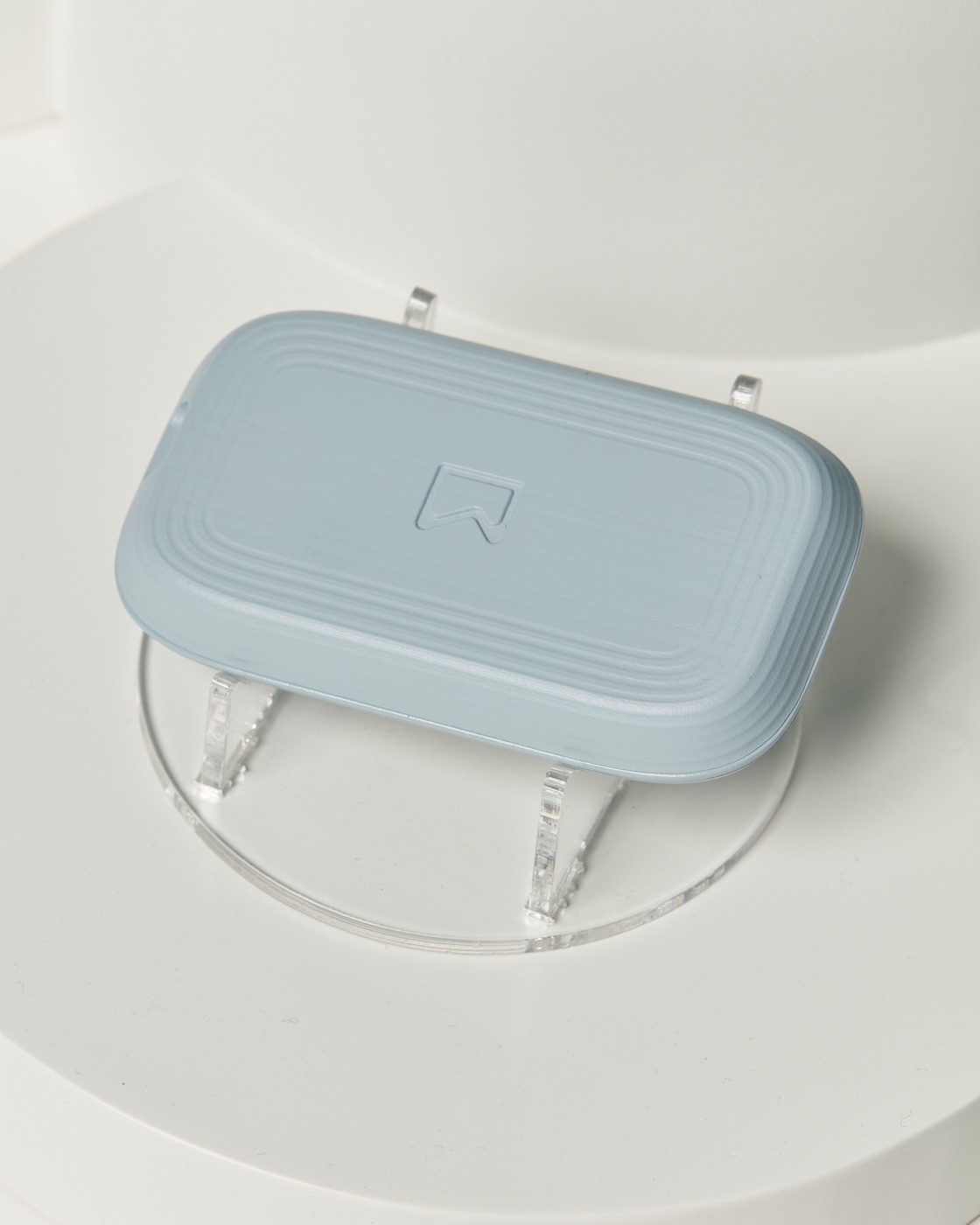 The back of the Kali monitor seen from above on its clear stand, showing the layered ridge detail and logo.