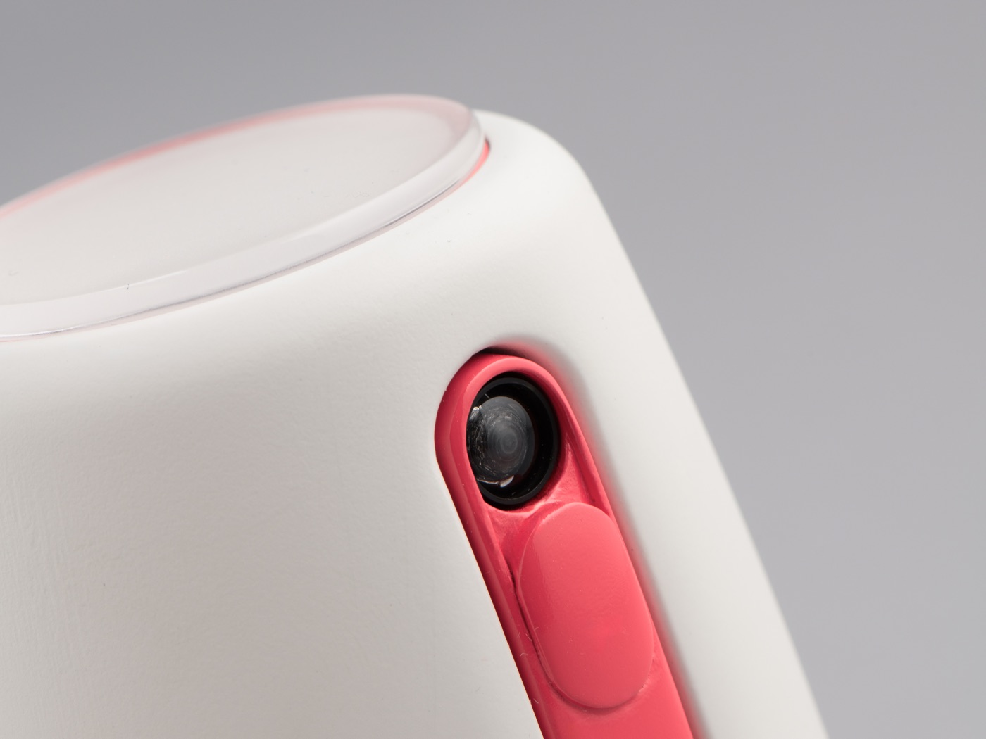 Close-up of the Airbnb Savour cooking companion: a white body with a clear top, and a coral slider beside the camera lens.